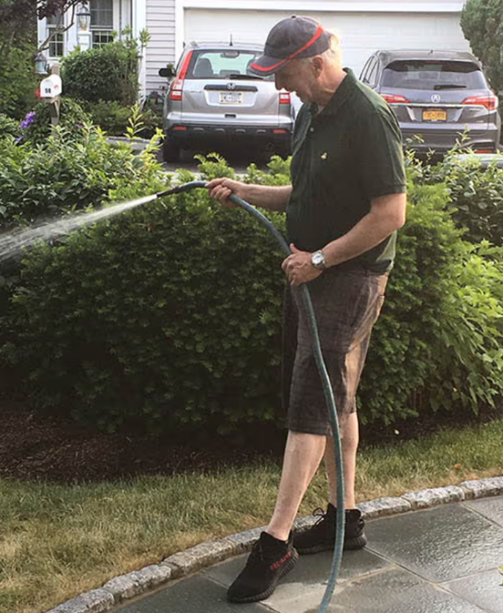 man watering the garden wearing Comprex Ankle Sleeves